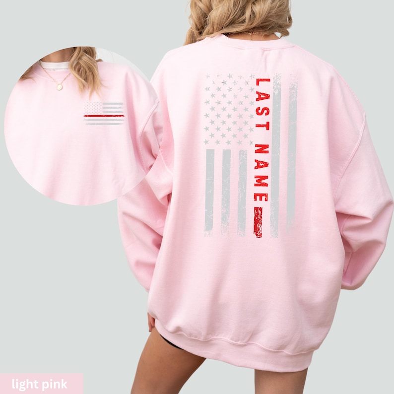 a woman wearing a pink sweatshirt with an american flag on it