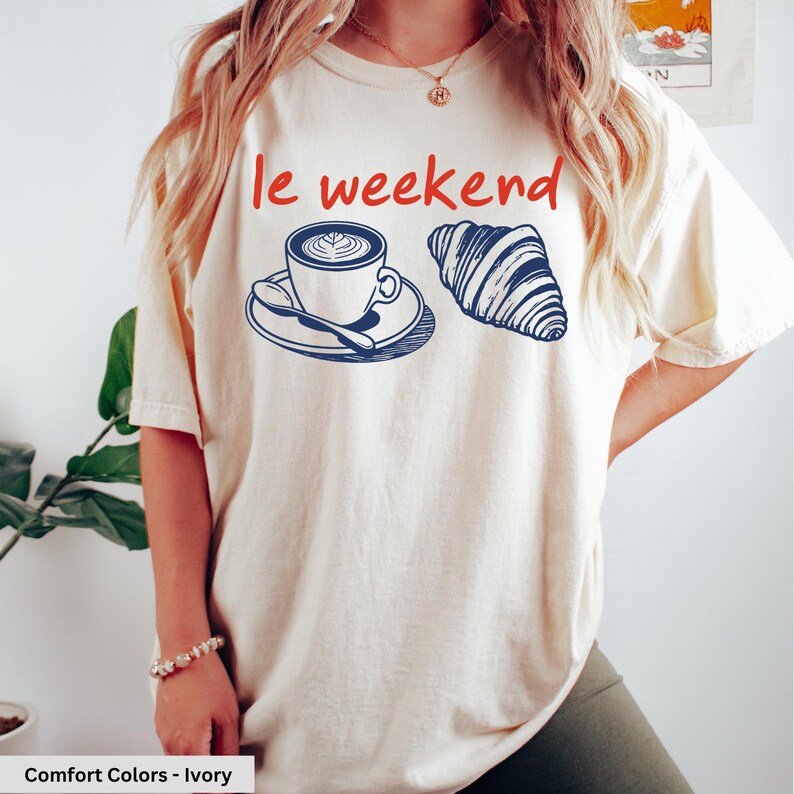 a woman wearing a t - shirt that says i weekend with a cup of coffee