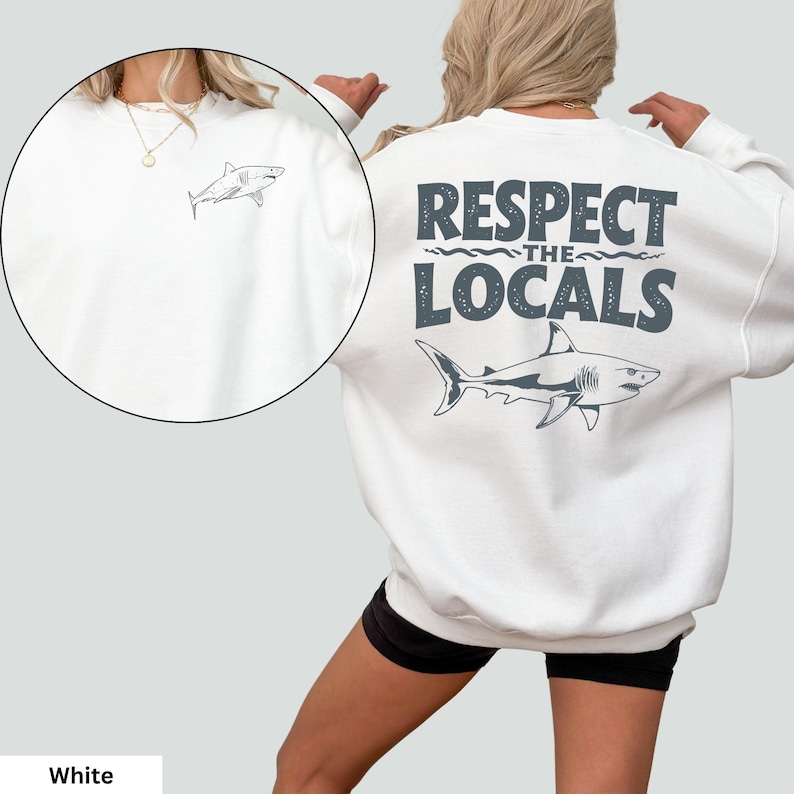 a woman wearing a white sweatshirt that says respect the locals