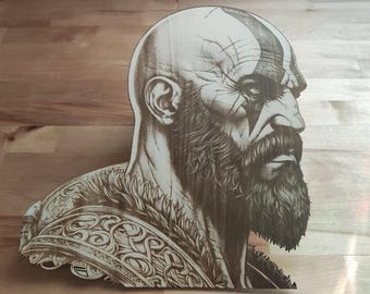 May include: Wooden portrait of a bald, bearded man with a prominent scar on his head. The artwork features detailed shading and intricate patterns on the shoulder armor. The piece is likely a depiction of a character from a video game or mythology.