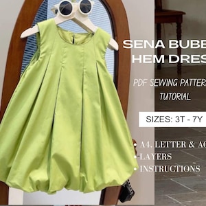 Puede incluir: Vestido con bajo abombado verde lima en una percha blanca. El vestido tiene un escote redondo y una falda amplia y fruncida. El texto de la imagen dice "SENA BUBBLE HEM DRESS" y "PDF SEWING PATTERN + TUTORIAL". Tallas: 3T-7Y.