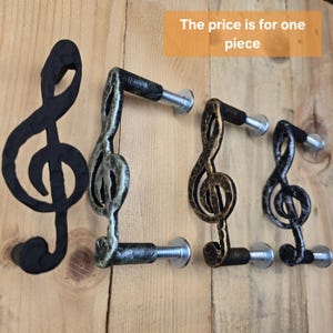 以下が含まれることがあります： 黒いものが2つ、金色が1つ、銀色が1つの、4つの音符の形をしたキャビネットノブ。価格は1個分です。