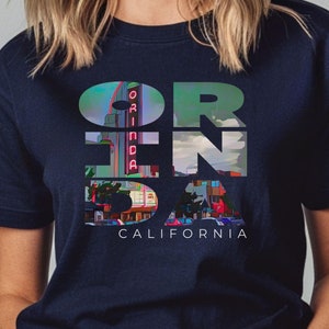 Navy shirt featuring Orinda California text with the iconic Orinda Theatre design integrated into the letters. Simple and stylish, this tee is perfect for showcasing local pride and celebrating Orinda and Lamorinda’s charm in the East Bay
