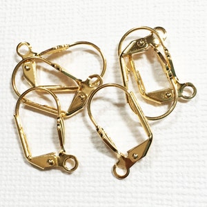 May include: Four gold-tone earring clip-on findings. The findings are made of metal and have a smooth finish.