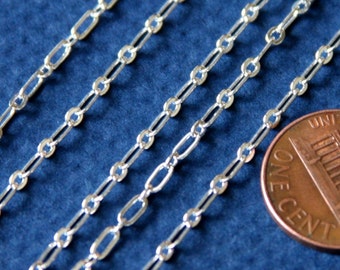 May include: Four silver chains of different lengths, laid out on a blue surface, with a UK penny for scale.