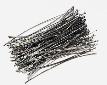 May include: A pile of silver-colored head pins, used for attaching jewelry findings and other small objects.