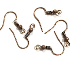May include: Four copper-toned metal earring hooks, each featuring a curved wire, a small decorative coil, a round bead, and a bottom loop for attaching jewelry components. These earring findings are designed for crafting custom jewelry pieces.