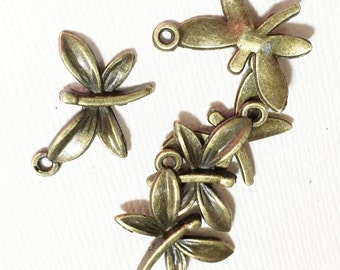 May include: Five antique gold-toned dragonfly charms with intricate details. Each charm has a loop for attaching to jewelry or other crafts.