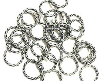 May include: A collection of multiple silver-toned metal jump rings, each featuring a twisted, rope-like texture. These circular connectors are arranged in a loose pile, showcasing their metallic sheen and the intricate, spiraled pattern of the wire.