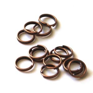 May include: A pile of 15 copper jump rings, a type of jewellery finding used for connecting chains, cords, and other jewellery components.