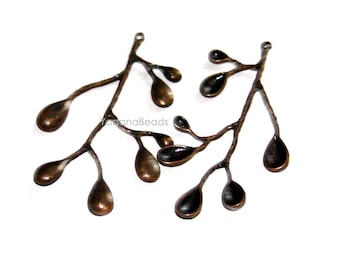 May include: Two antique copper-toned metal branch charms with small teardrop-shaped leaves. The charms are perfect for jewelry making or crafting.