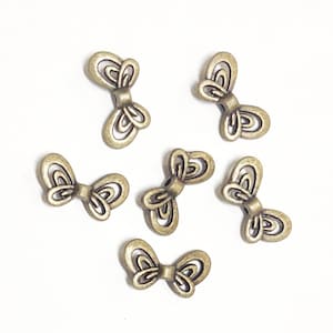 25 Antique Brass Butterfly Spacer Beads: Zinc Alloy (17x9mm)