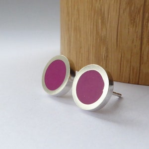 small round silver and magenta stud earrings on a white background