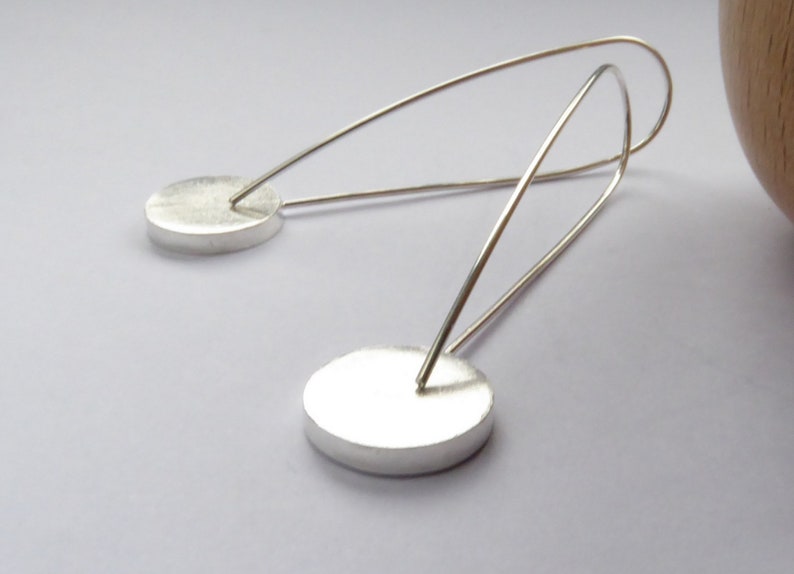 back view of Pop long round recycled Sterling Silver earrings