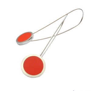 cut out on white background orange pop long drop earrings in resin and silver