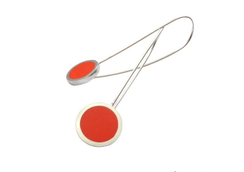 cut out on white background orange pop long drop earrings in resin and silver