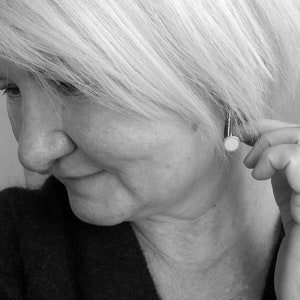 Pop five centimetre long Sterling Silver and resin earrings being modelled by a woman with a bob