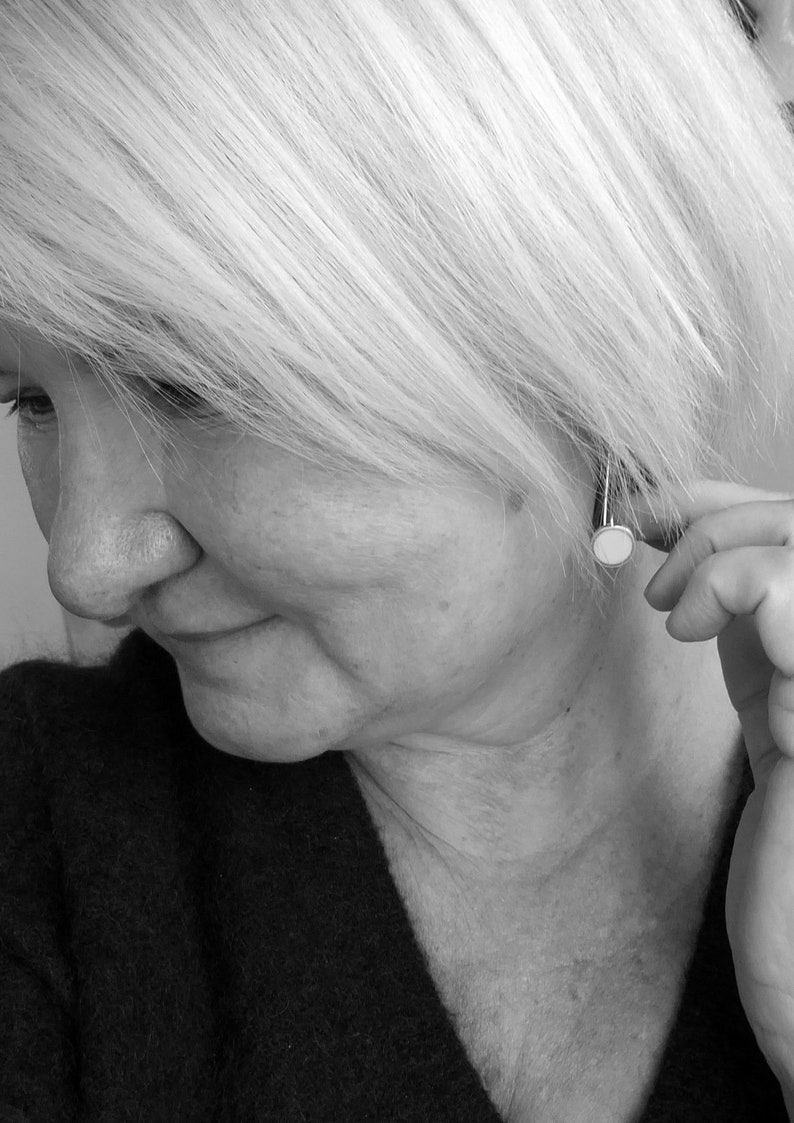 Pop five centimetre long Sterling Silver and resin earrings being modelled by a woman with a bob