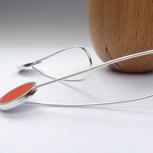 side view of Pop minimalist long orange earrings