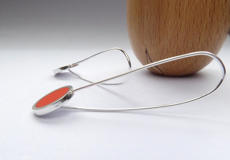 side view of Pop minimalist long orange earrings