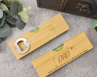 May include: Two bamboo bottle opener levels. One has a bottle opener and a level bubble. The other has the word "DAD" engraved with stars and the text "YOU ARE A BEAM OF LIGHT IN MY LIFE. SHININGLY ILLUMINATING. LOVE JURRY HOWARD."