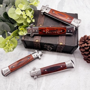 May include: Four silver and wood pocket knives with a red and brown wood pattern. The knives are closed and have a spring-loaded mechanism. One knife has the name "Rowe" engraved on the handle.