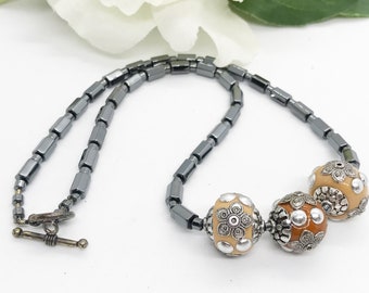 Handmade Minimalist Hematite Beaded Necklace with Indonesian Embellished Caramel Beads, Sterling Toggle 18 Inches