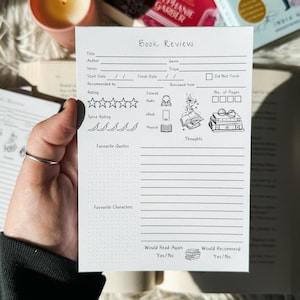 May include: A black and white printable book review tracker with a dotted background. The tracker includes sections for title, author, series, start date, finish date, recommended by, rating, spice rating, format, genre, trope, borrowed from, number of pages, favourite quotes, favourite characters, thoughts, would read again, and would recommend.