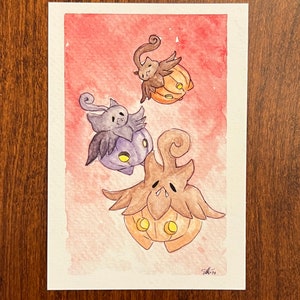 May include: Watercolor painting of three cartoon pumpkins with faces. The pumpkins are flying in the air against a pink and orange background.