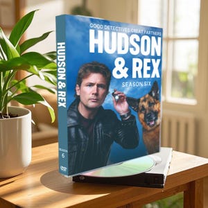 May include: DVD box cover for the TV show "Hudson & Rex", season six. The cover features a man and a German Shepherd dog against a blue sky background. The text on the cover reads "Good Detectives. Great Partners. Hudson & Rex. Season Six."