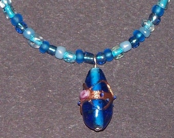 blue glass necklace with lampwork pendant