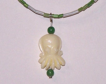 green beaded necklace with cephalopod pendant