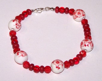 red bracelet with ceramic floral beads