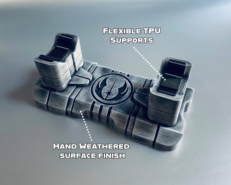May include: A weathered gray TPU stand with flexible supports, featuring a hand-weathered surface finish. The stand has a symbol in the center and text that reads "FLEXIBLE TPU SUPPORTS" and "HAND WEATHERED SURFACE FINISH".