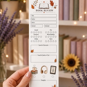 May include: A white rectangular book review bookmark featuring an open book icon, autumn leaves, and fields for title, author, genre, and dates. It includes star and pumpkin rating scales, sections for favorite characters and quotes, and icons for reading.