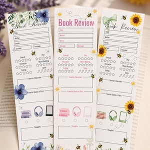 May include: Three vertical paper book review inserts featuring floral and bee illustrations. Each includes fields for title, author, genre, dates, and star ratings for plot, characters, and spice. Icons for books, headphones, and e-readers are included.