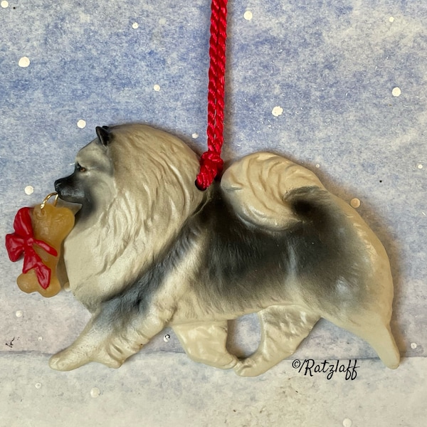 Keeshond with bone. Christmas/holiday artist dog breed ornament. Handcrafted by Artdog Ornaments.