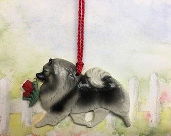 Keeshond with red tulip charm. Christmas/holiday artist dog breed ornament. Handcrafted by Artdog Ornaments.