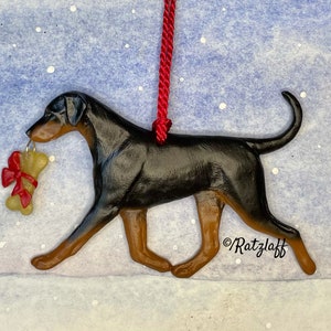Doberman w/ bone charm and natural ears and tail. Blue and tan. Artist sculpted dog breed Christmas ornament.