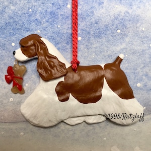 American Cocker Spaniel with bone charm-red and white-Christmas/holiday handcrafted dog breed ornament.