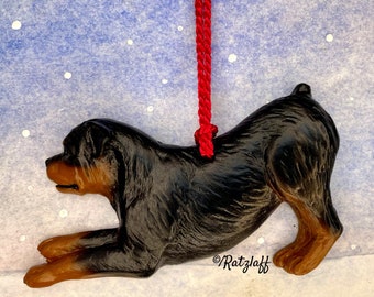 Rottweiler in a play bow. Christmas/holiday dog breed ornament.