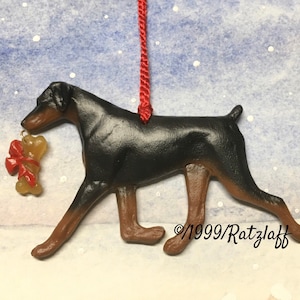 Doberman w/ bone charm and natural ears. Black and tan. Artist sculpted dog breed ornament by Artdog Ornaments.