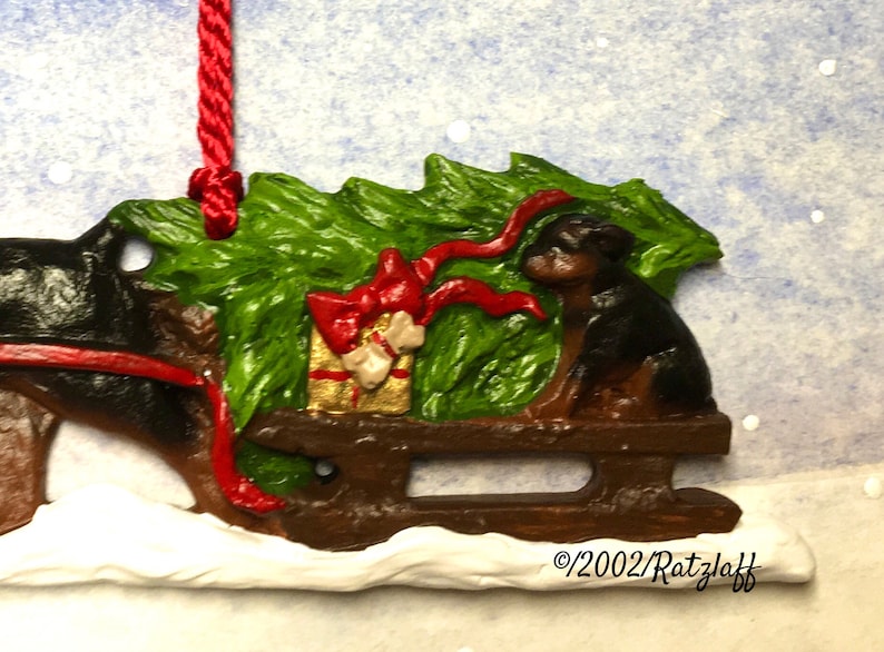 Sled Rotties Rottweiler With Puppy on Sled. Bringing the Christmas Tree Home. Dog ...