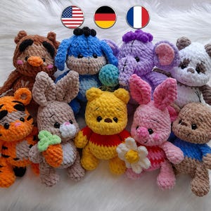 May include: A collection of handmade crochet plush toys in various colors. The toys include a tiger, rabbit, bear, panda, elephant, and Winnie the Pooh characters. Each toy has unique features and expressions, perfect for children.