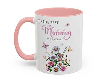 May include: White ceramic mug with a pink handle and interior. The mug features the text "TO THE BEST Mummy IN THE WORLD" in a script font, along with floral and butterfly illustrations. A perfect gift for Mother's Day.