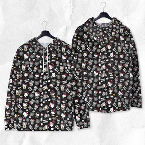 May include: Two black hoodies with a repeating pattern of Hello Kitty characters, snowflakes, and text. The hoodies are hanging on black hangers against a textured white background. The text reads "Hello Kitty".