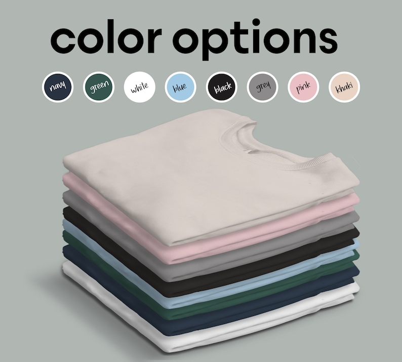 May include: A stack of folded t-shirts in various colors, including white, pink, grey, black, blue, green, and navy. The colors are displayed in a row above the stack of shirts. The text "color options" is displayed above the colors.