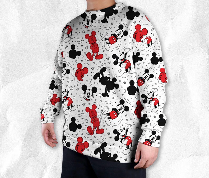 May include: White sweatshirt with a repeating pattern of Mickey Mouse in red, black, and white. The design includes full-body images, silhouettes, and Mickey Mouse heads, with hearts and stars scattered throughout.