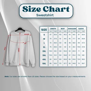 May include: White sweatshirt with a size chart graphic. The chart displays measurements in inches and centimeters for length, bust, shoulder, and sleeve for sizes S to 5XL. The text at the top reads "Size Chart Sweatshirt."