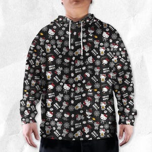 May include: Black hoodie with a repeating pattern of Hello Kitty characters in Halloween costumes, pumpkins, and spiderwebs. The words "Hello Kitty" are also printed throughout the design. The hoodie has a drawstring hood and long sleeves.